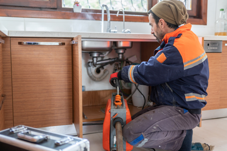 plumber repairing sink plumbing