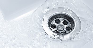 water flowing into sink drain
