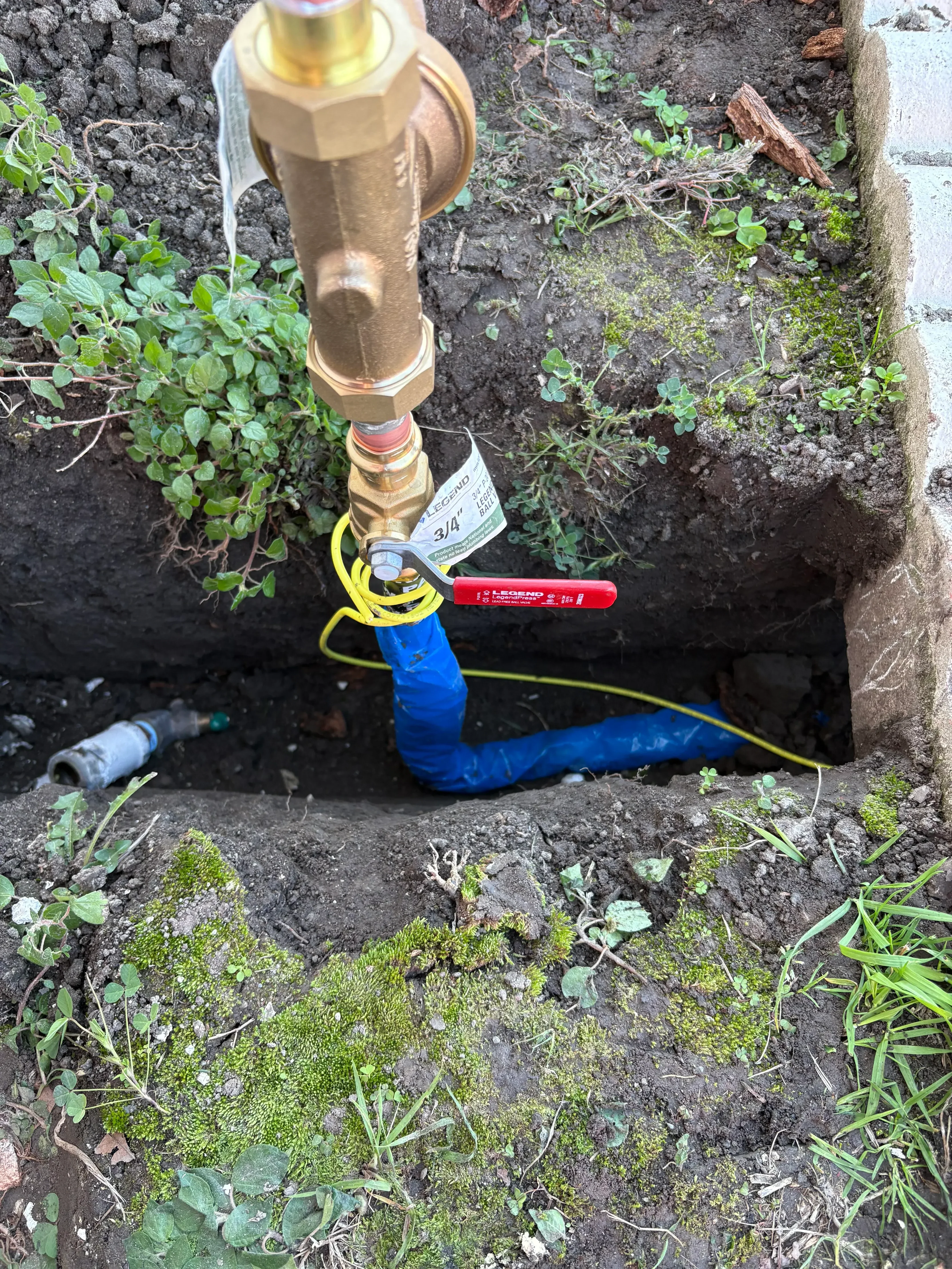 Brass water main valve with shutoff assembly installed in underground utility box